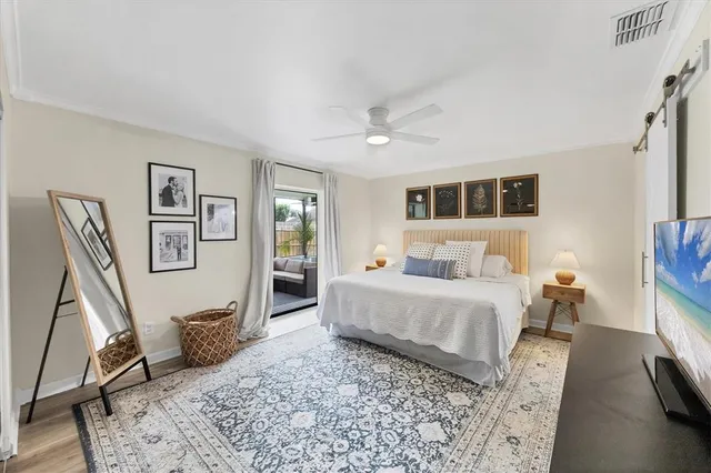 a bed room with furniture and a flat screen tv