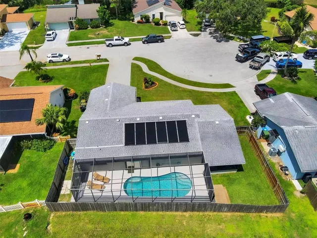 an aerial view of a house with a swimming pool yard and outdoor seating