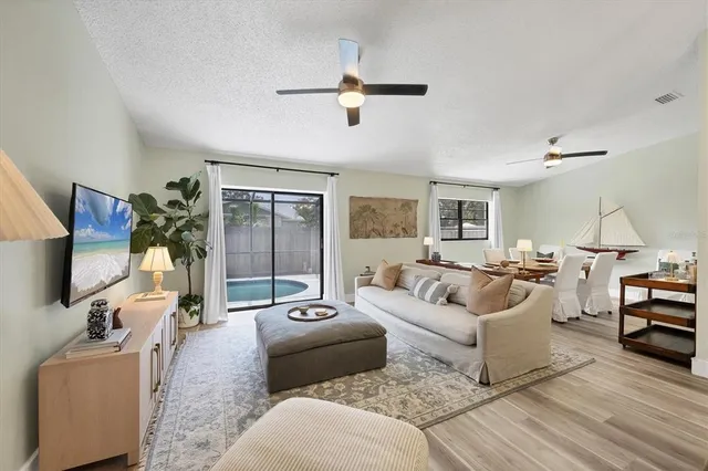 a living room with furniture gym equipment and a flat screen tv