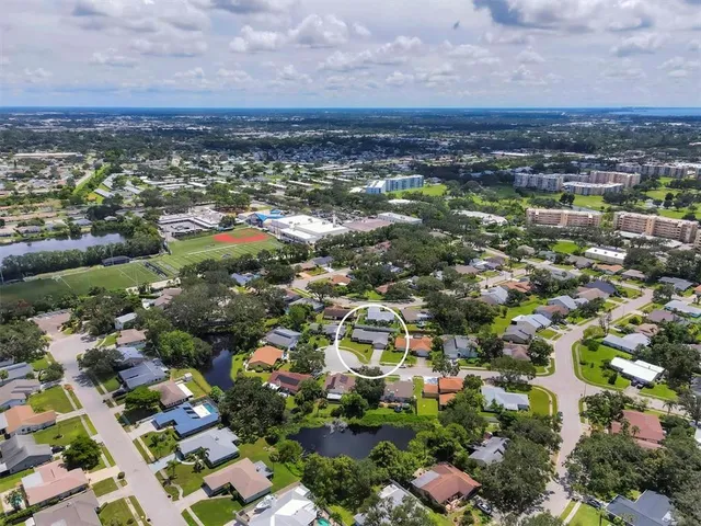 an aerial view of residential houses with city view