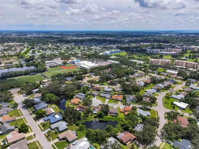an aerial view of residential houses with city view