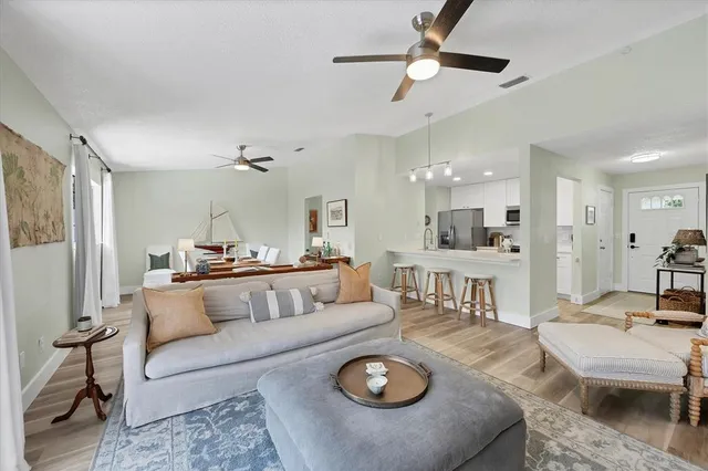 a living room with furniture and kitchen view