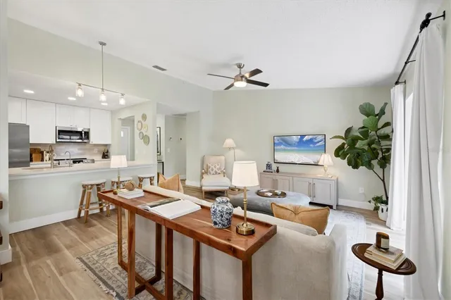 a living room with furniture a chandelier and a table