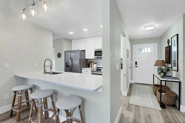 a kitchen with stainless steel appliances a sink stove and refrigerator
