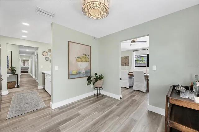 a view of a room with wooden floor and a potted plant
