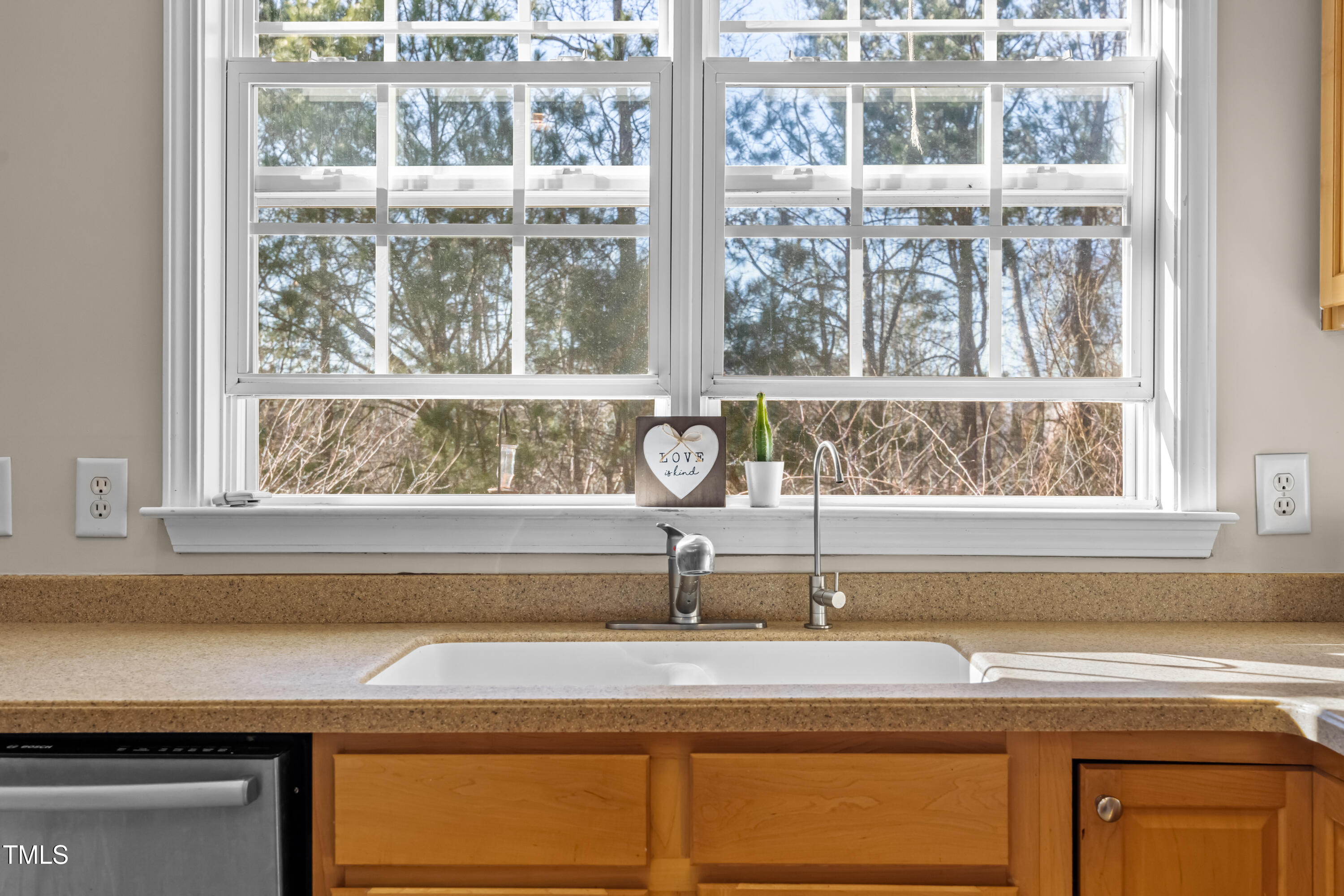 7772 Silver View Lane Raleigh, NC 27613 - Photo 11 of 55 a bathroom with a sink and mirror with window
