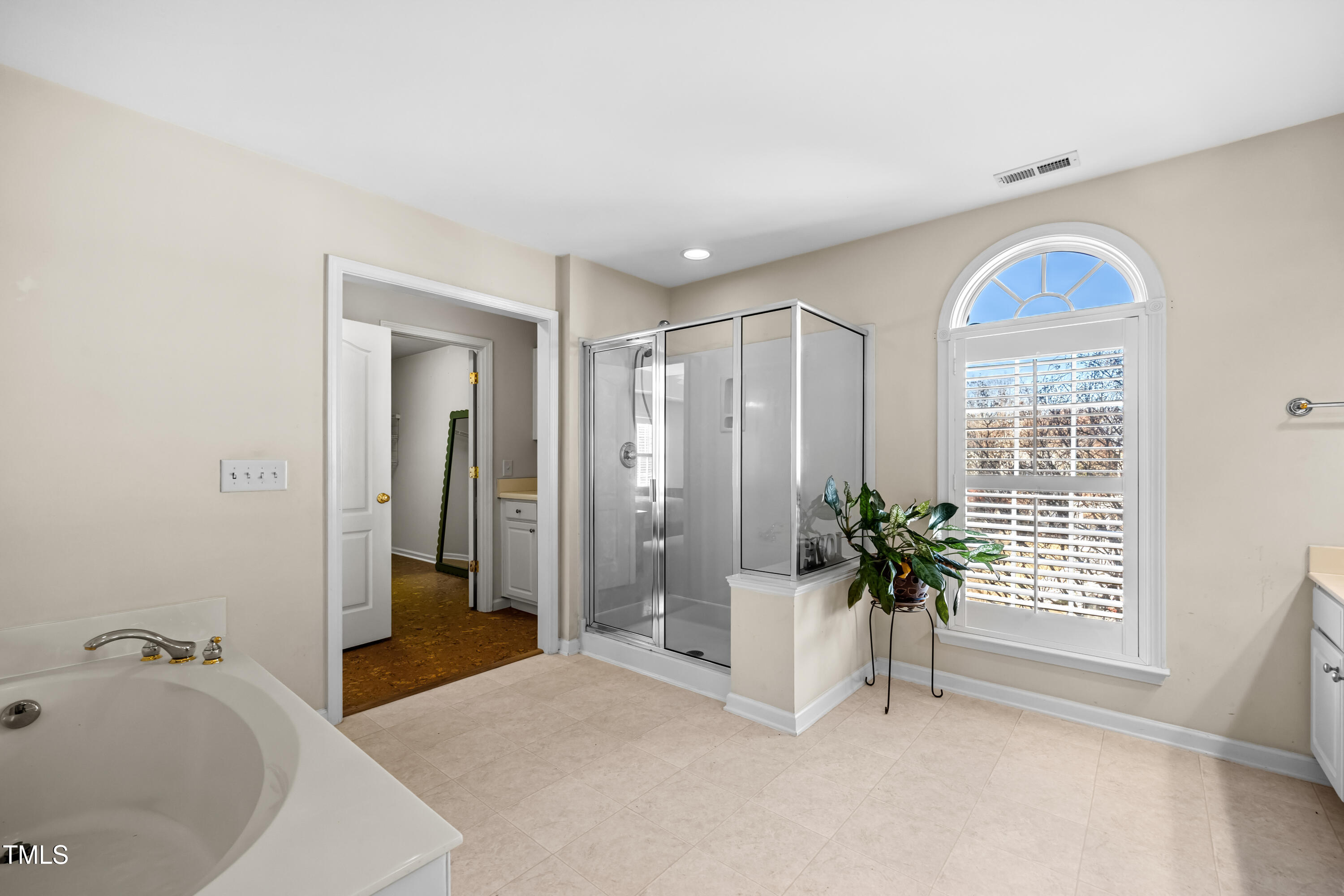7772 Silver View Lane Raleigh, NC 27613 - Photo 21 of 55 a bathroom with a tub and shower