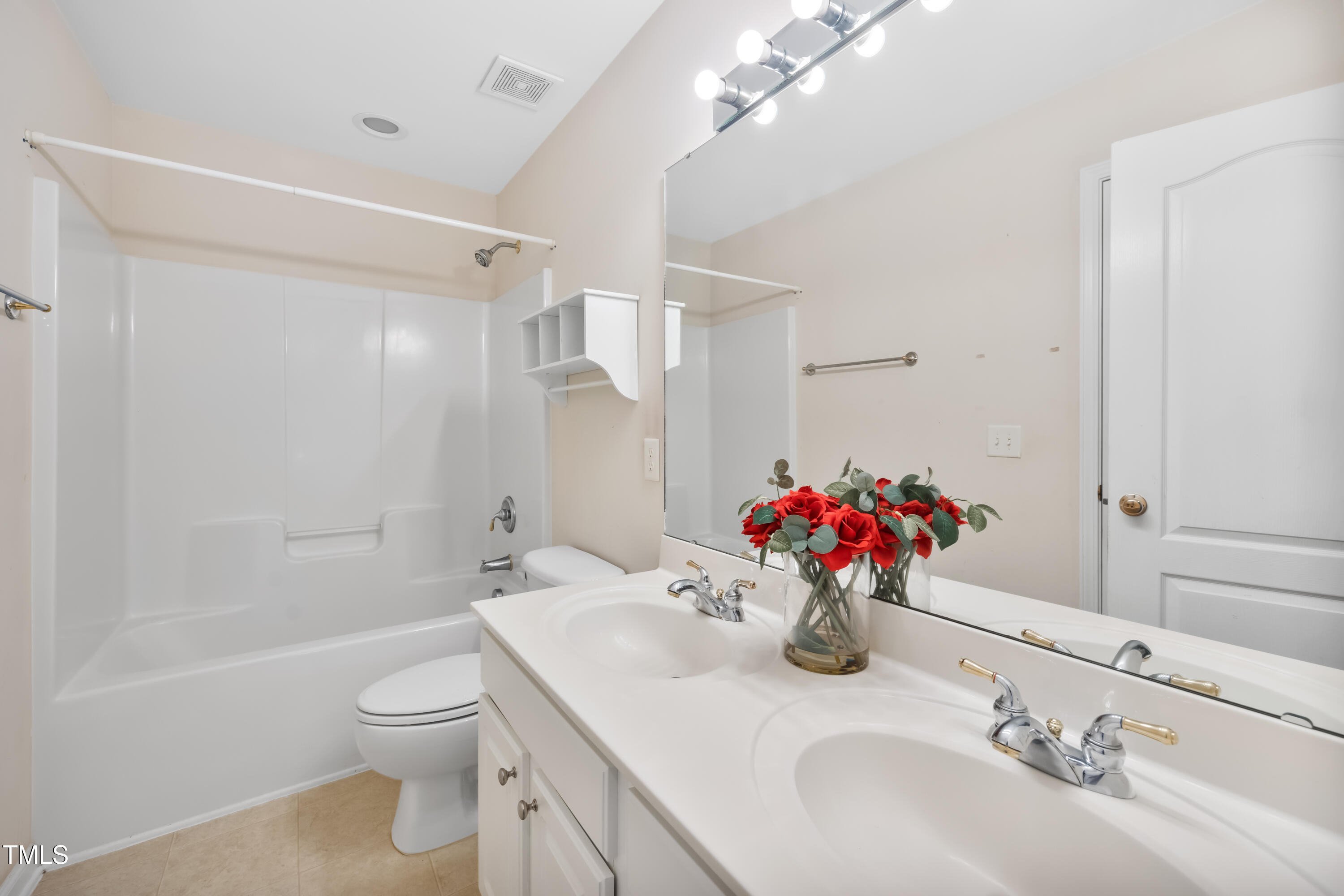 7772 Silver View Lane Raleigh, NC 27613 - Photo 26 of 55 a bathroom with a sink vanity mirror and toilet