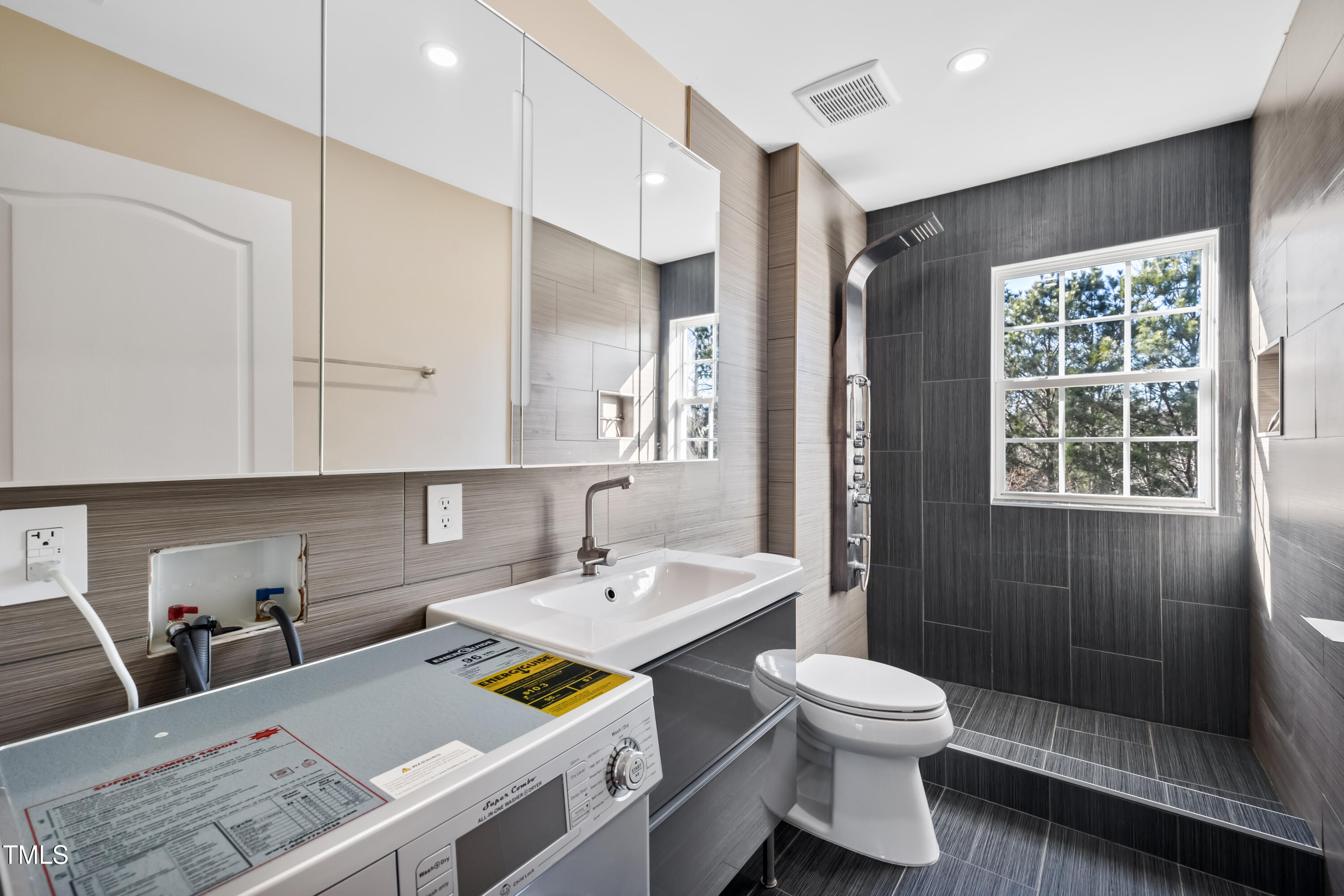 7772 Silver View Lane Raleigh, NC 27613 - Photo 29 of 55 a bathroom with a sink toilet and shower
