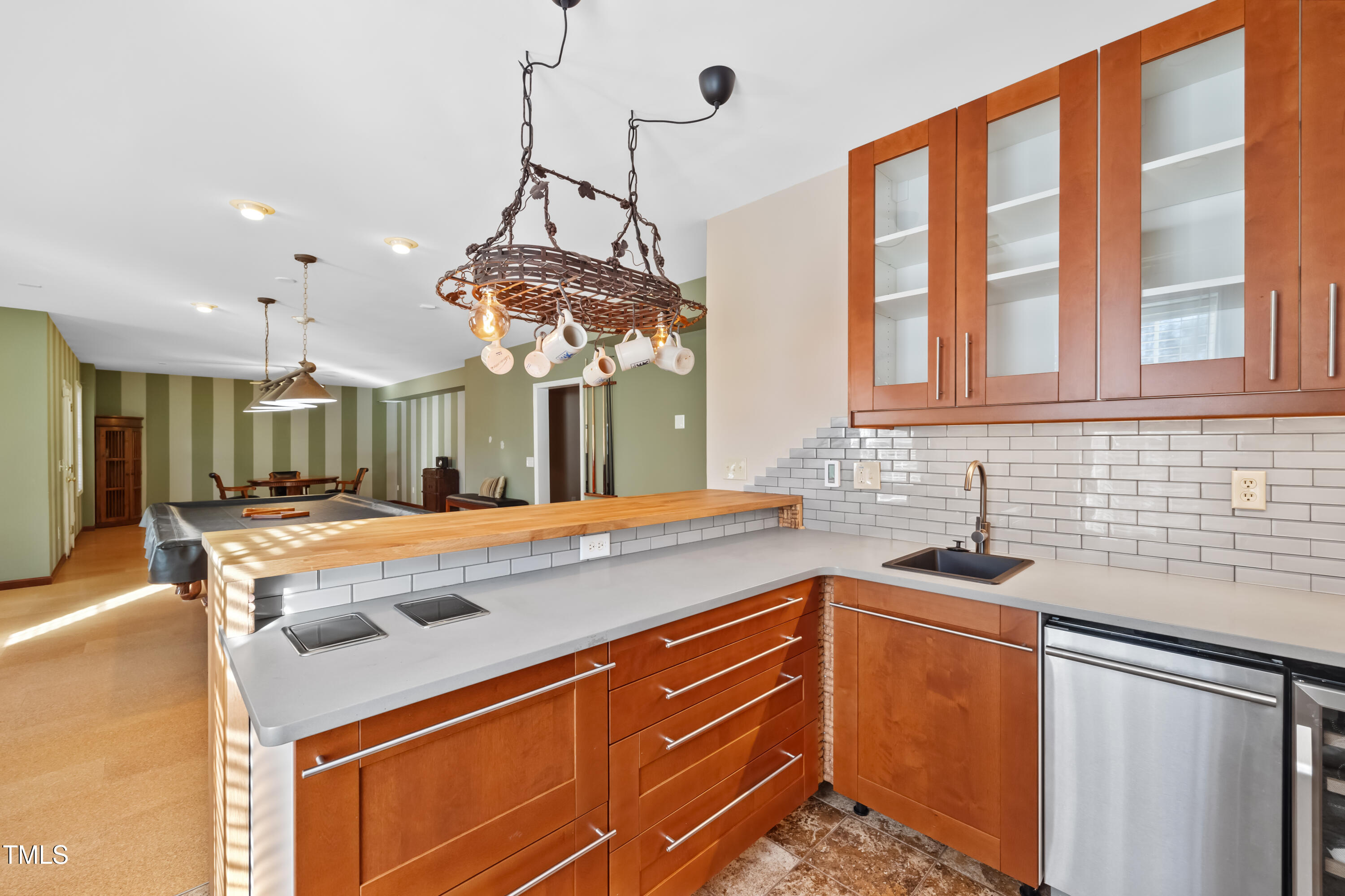 7772 Silver View Lane Raleigh, NC 27613 - Photo 37 of 55 a kitchen with stainless steel appliances granite countertop a sink a counter space and a chandelier