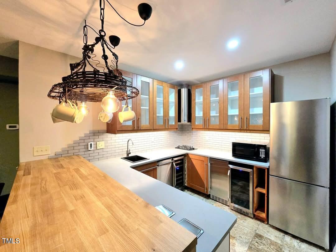 7772 Silver View Lane Raleigh, NC 27613 - Photo 40 of 55 a kitchen with stainless steel appliances granite countertop a sink a stove and refrigerator