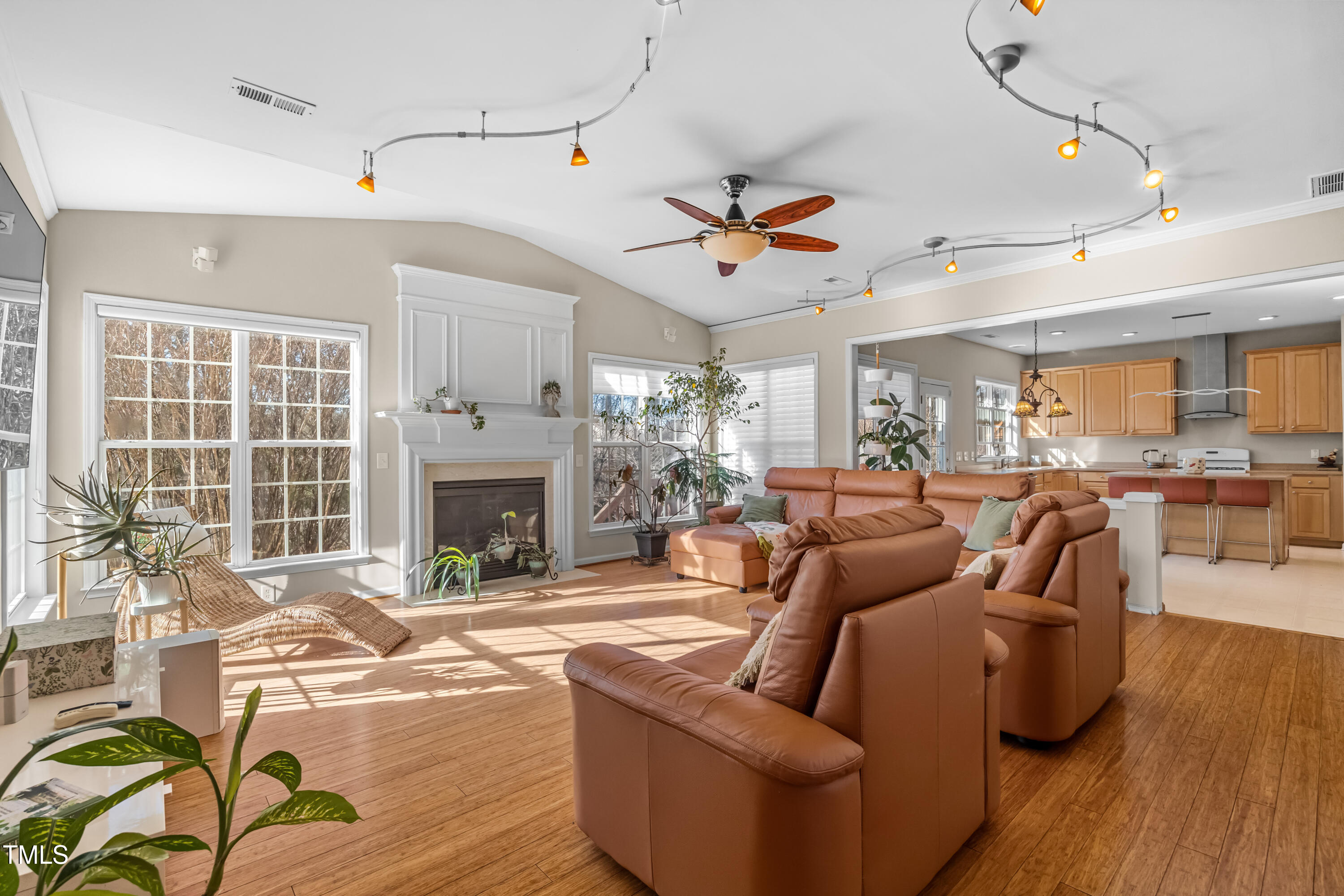 7772 Silver View Lane Raleigh, NC 27613 - Photo 5 of 55 a living room with furniture a fireplace and a table