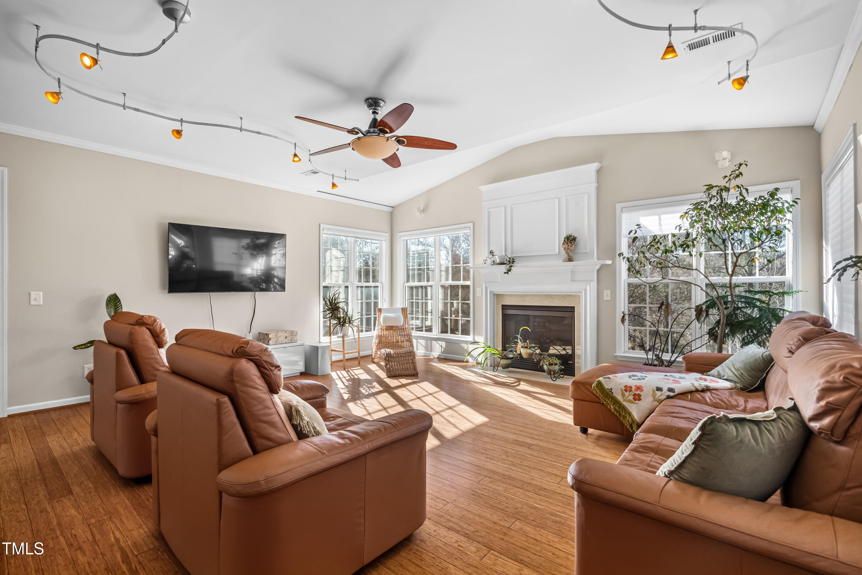 7772 Silver View Lane Raleigh, NC 27613 - Photo 6 of 55 a living room with furniture a fireplace and a flat screen tv