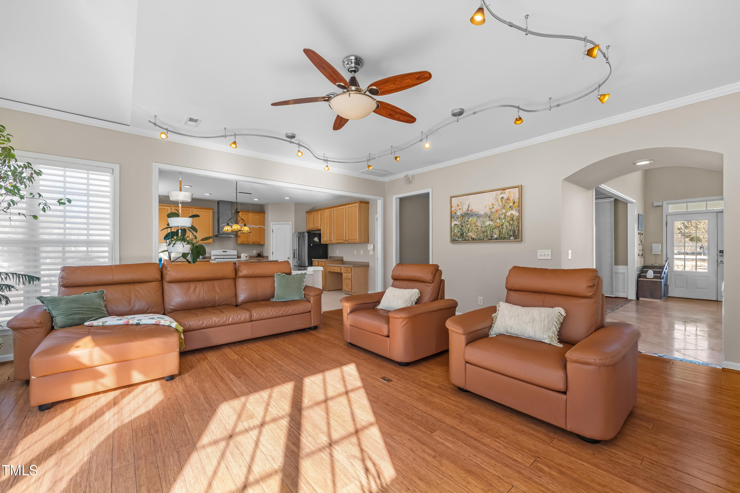 7772 Silver View Lane Raleigh, NC 27613 - Photo 7 of 55 a living room with furniture kitchen view and a wooden floor