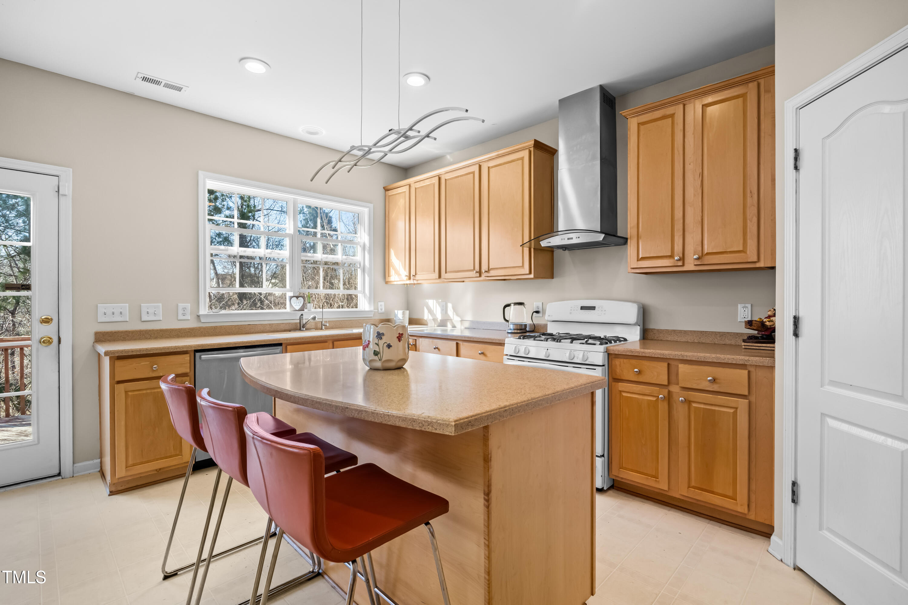 7772 Silver View Lane Raleigh, NC 27613 - Photo 9 of 55 a kitchen with stainless steel appliances granite countertop a sink a stove a table and chairs