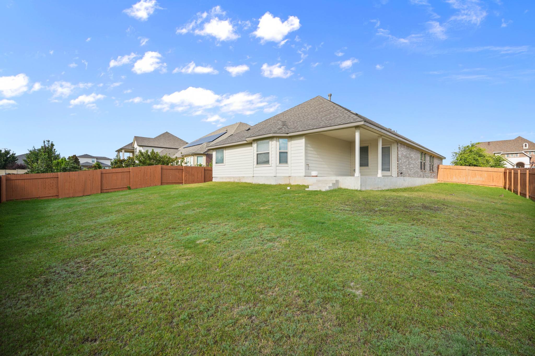 2209 Hat Bender Loop Round Rock, TX 78664 - Photo 22 of 25 a front view of house with yard and trees
