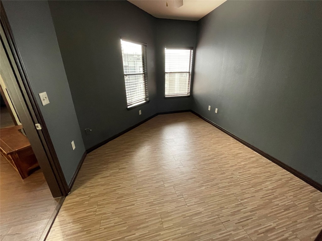 2502 Leon Street, Unit 505 Austin, TX 78705 - Photo 13 of 28 an empty room with wooden floor and windows