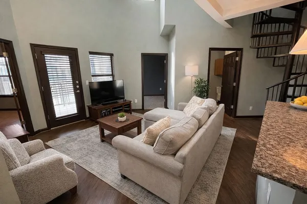 a living room with furniture fireplace and a flat screen tv
