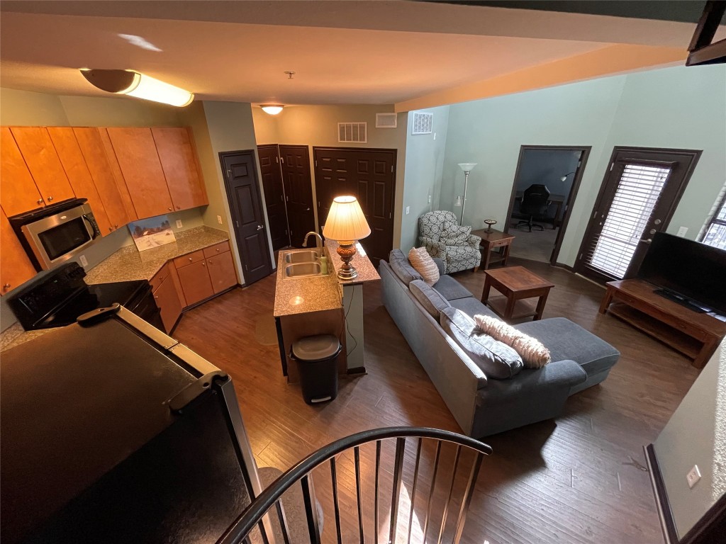2502 Leon Street, Unit 505 Austin, TX 78705 - Photo 23 of 28 a living room with furniture and a flat screen tv