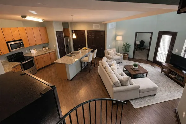 a living room with furniture window and a flat screen tv