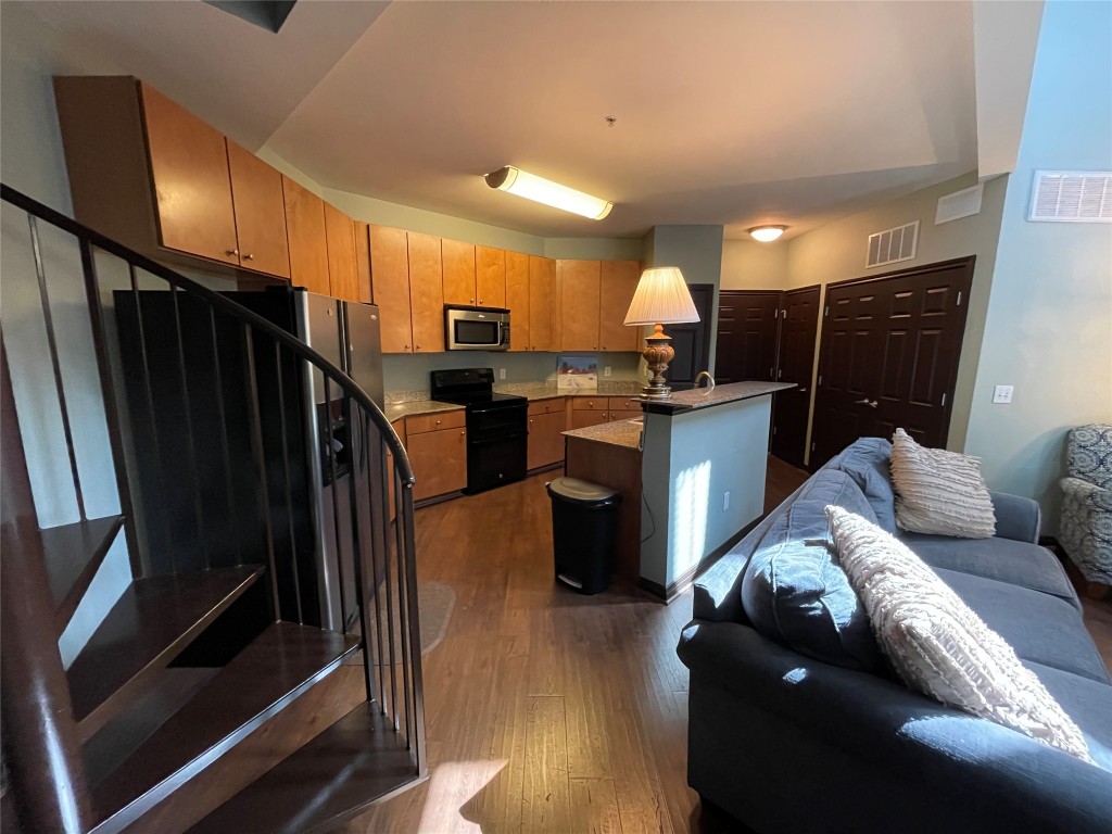 2502 Leon Street, Unit 505 Austin, TX 78705 - Photo 26 of 28 a living room with stainless steel appliances furniture and a kitchen view