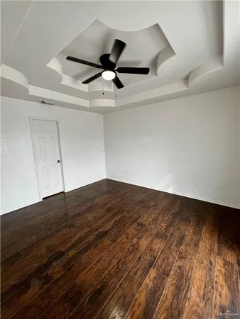 a view of a ceiling fan and wooden floor