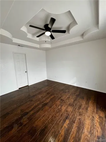 a view of a ceiling fan and wooden floor