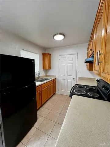 a kitchen with a refrigerator a stove a microwave and cabinets