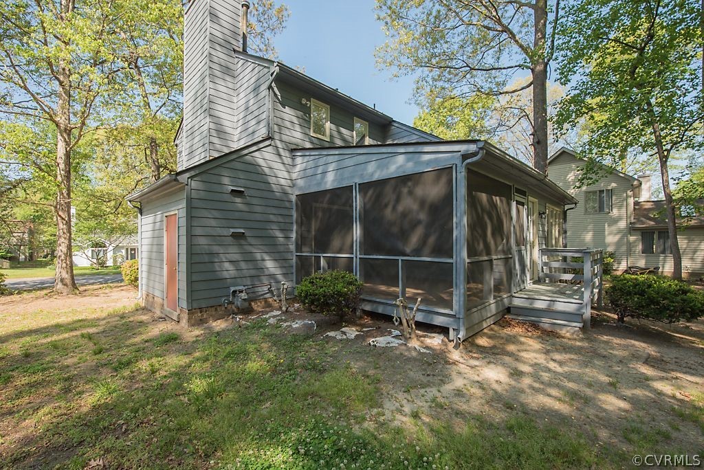 13805 Sandy Oak Road Chester, VA 23831 - Photo 27 of 28 a view of a house with a yard and wooden fence