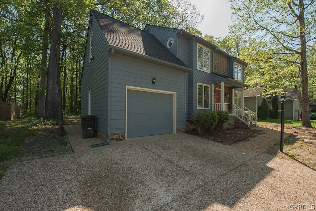13805 Sandy Oak Road Chester, VA 23831 - Photo 3 of 28 a front view of a house with garden