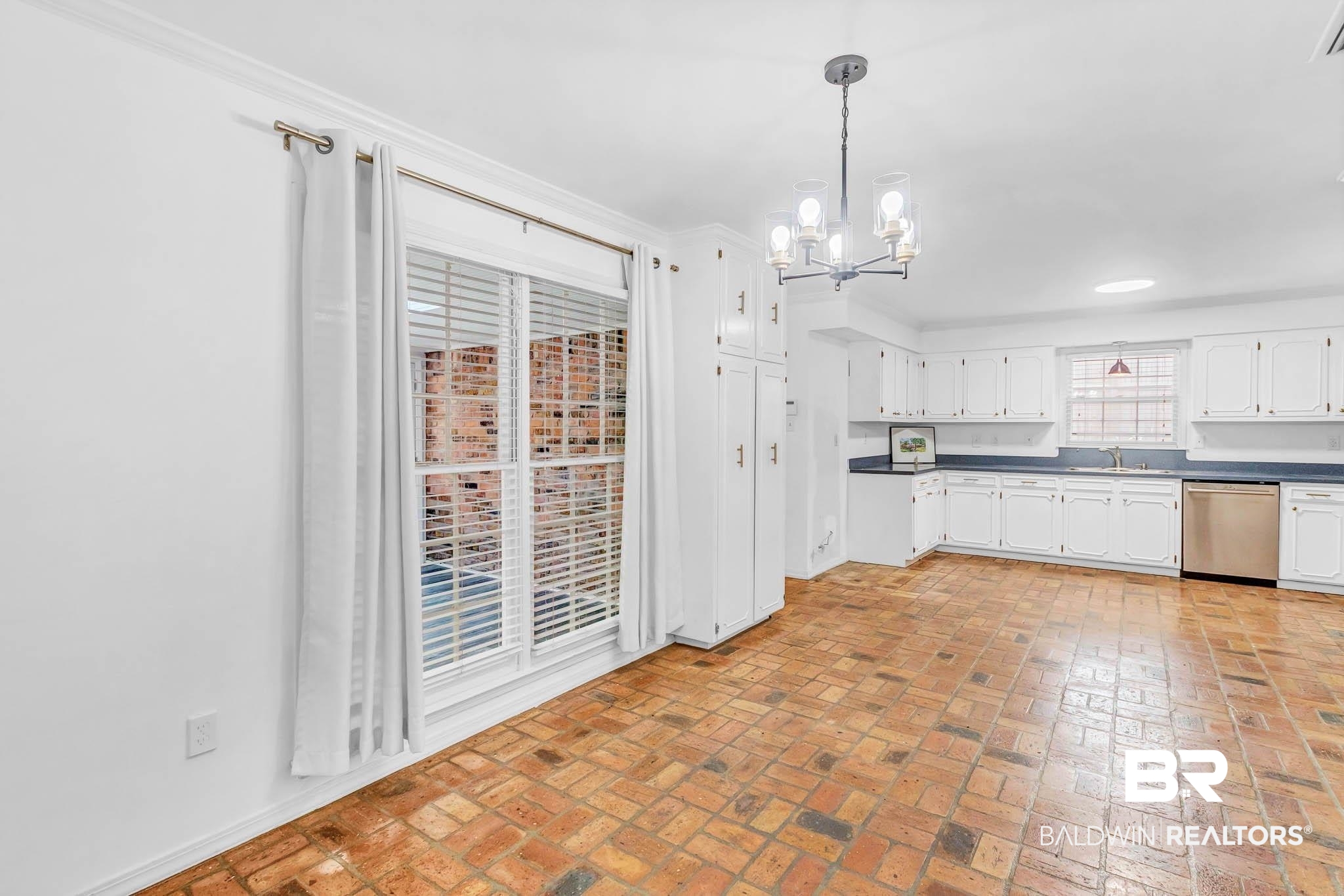 309 West Brandy Run Road Mobile, AL 36608 - Photo 26 of 100 Kitchen with a chandelier, white cabinetry, brick floors, dishwasher, and decorative light fixtures