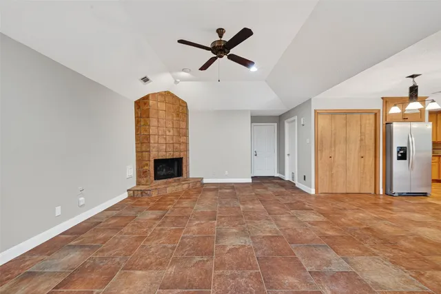 a view of a room with wooden floor and windows