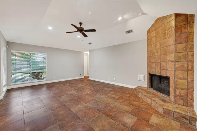 a view of an empty room with a ceiling fan