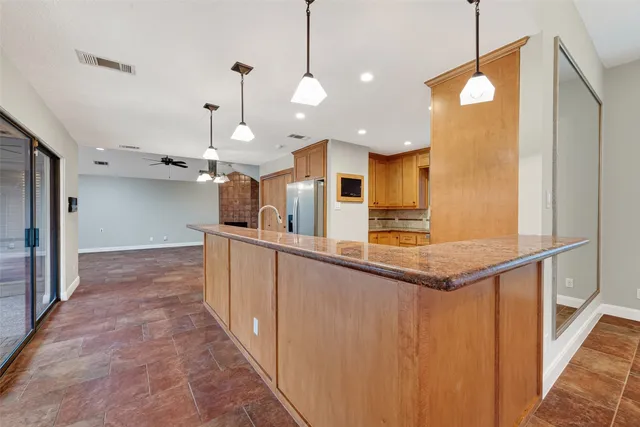 a kitchen with granite countertop cabinets stainless steel appliances and a window