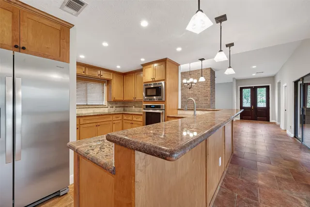 a view of a livingroom with a chandelier furniture and windows