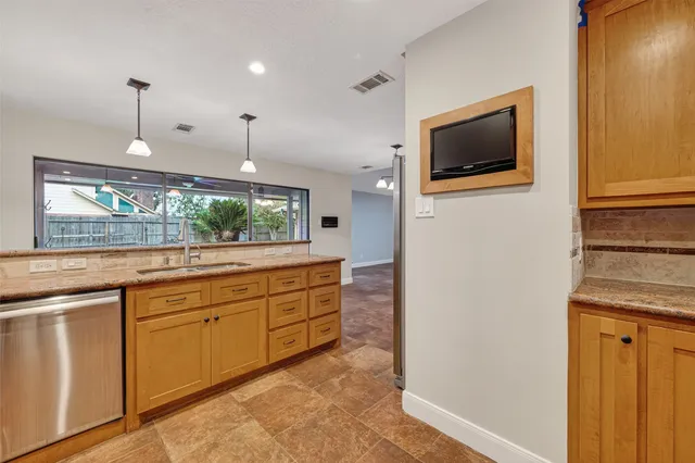 a view of an empty room with a fireplace and a chandelier