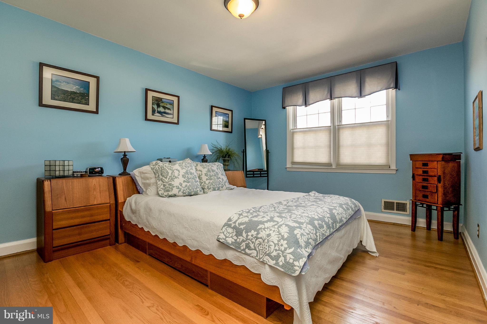 7120 Heathfield Road Baltimore, MD 21212 - Photo 13 of 29 a bedroom with a bed and a dresser next to a window