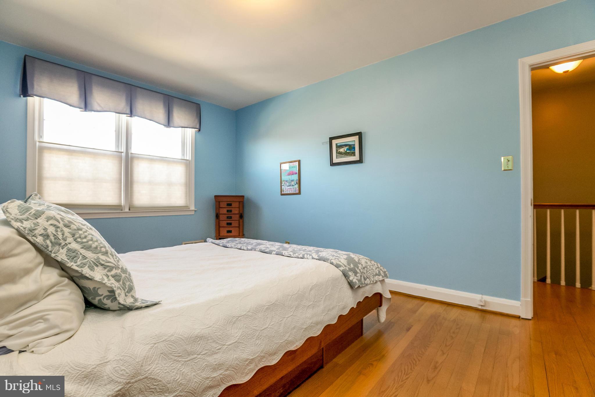 7120 Heathfield Road Baltimore, MD 21212 - Photo 14 of 29 a bedroom with a bed and wooden floor