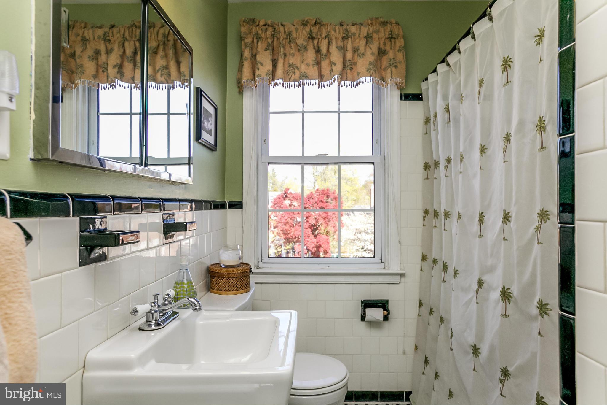 7120 Heathfield Road Baltimore, MD 21212 - Photo 17 of 29 a bathroom with a sink a toilet and a window