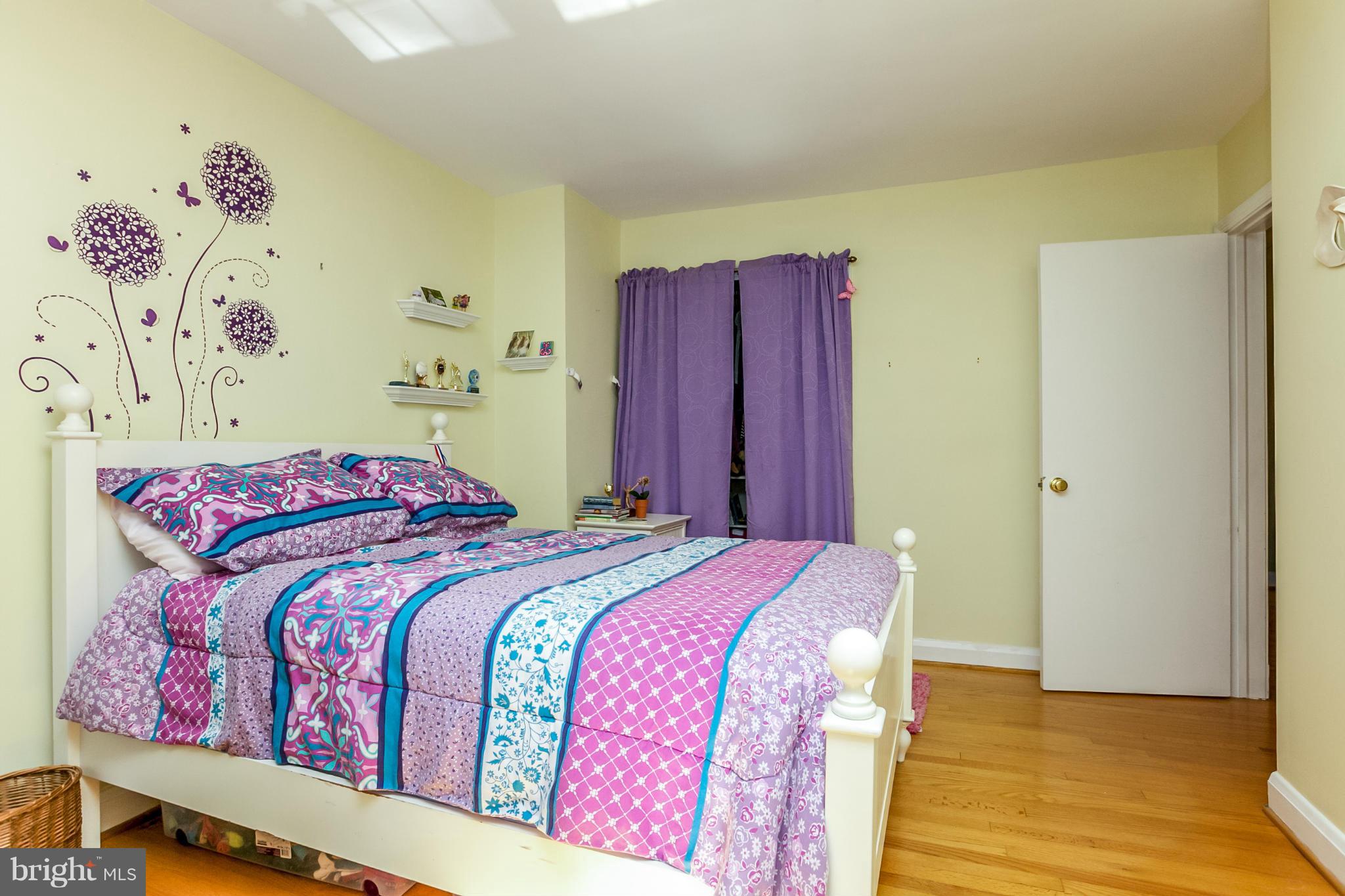 7120 Heathfield Road Baltimore, MD 21212 - Photo 21 of 29 a bedroom with a bed and wooden floor