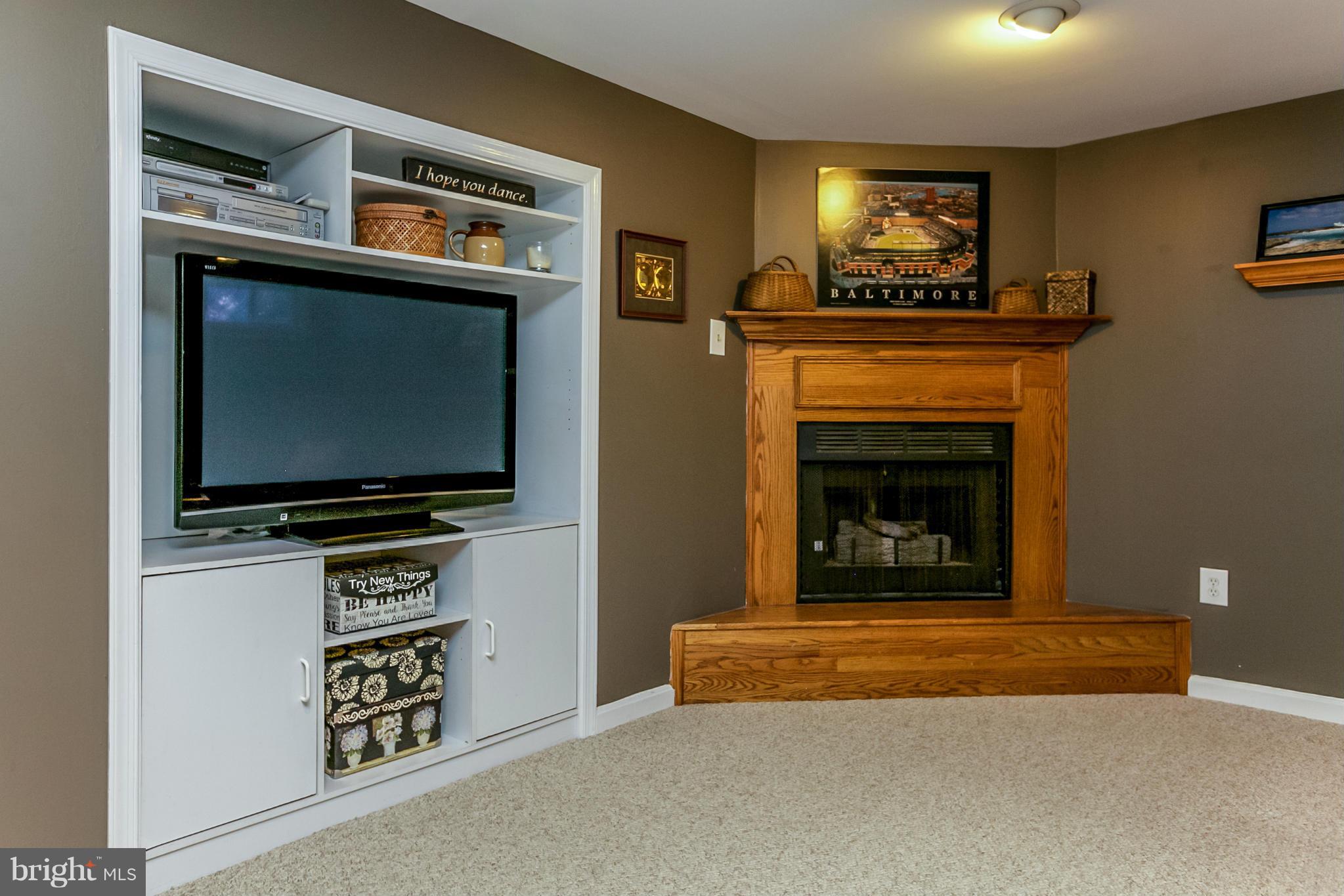 7120 Heathfield Road Baltimore, MD 21212 - Photo 23 of 29 a living room with a flat screen tv and a fireplace