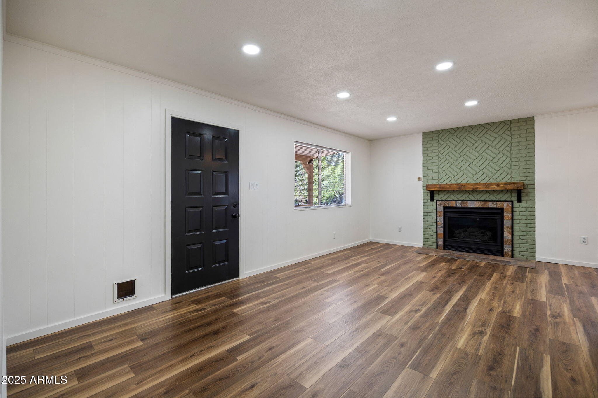 2127 Pony Road Overgaard, AZ 85933 - Photo 11 of 30 a view of an empty room with a fireplace and a window