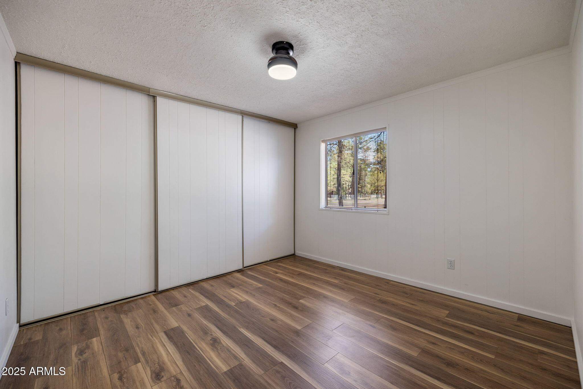 2127 Pony Road Overgaard, AZ 85933 - Photo 16 of 30 wooden floor in an empty room with a window