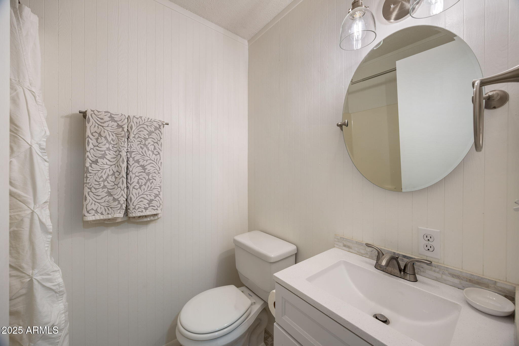 2127 Pony Road Overgaard, AZ 85933 - Photo 19 of 30 a bathroom with a toilet sink and mirror