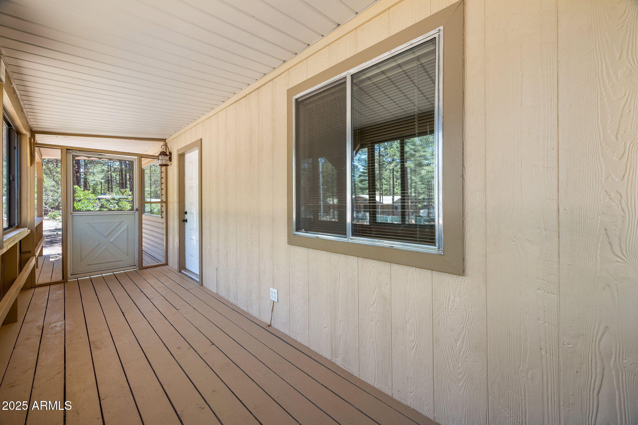 2127 Pony Road Overgaard, AZ 85933 - Photo 20 of 30 a view of an empty room with wooden floor and a window