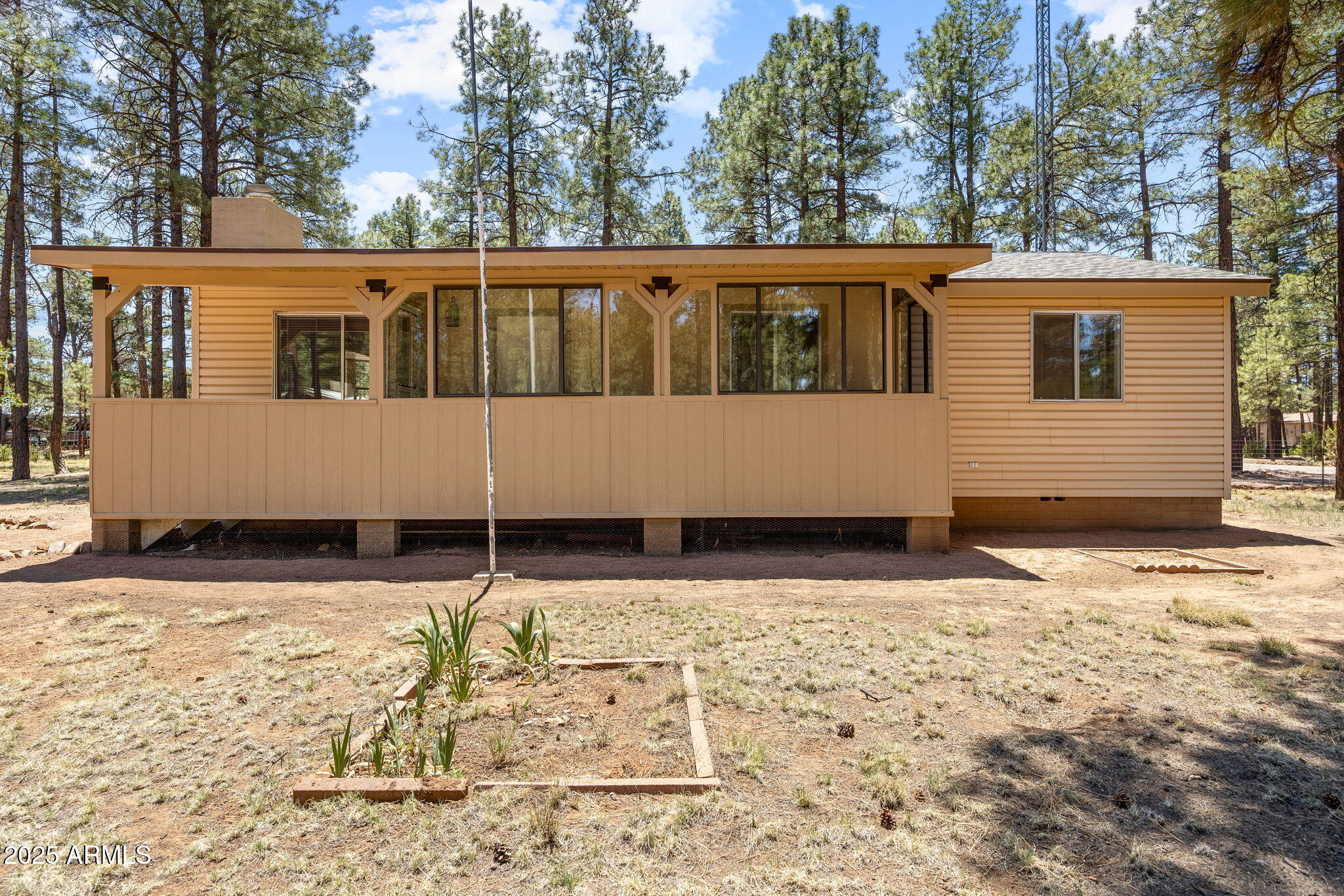 2127 Pony Road Overgaard, AZ 85933 - Photo 24 of 30 a house with trees in the background