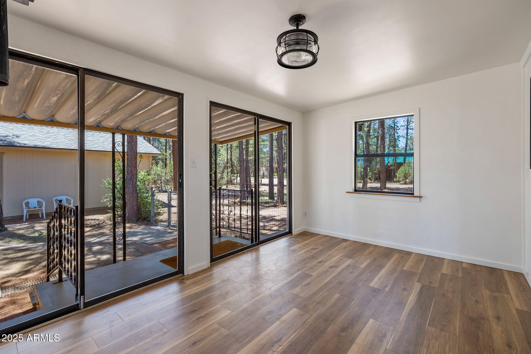 2127 Pony Road Overgaard, AZ 85933 - Photo 5 of 30 wooden floor in an empty room with a window