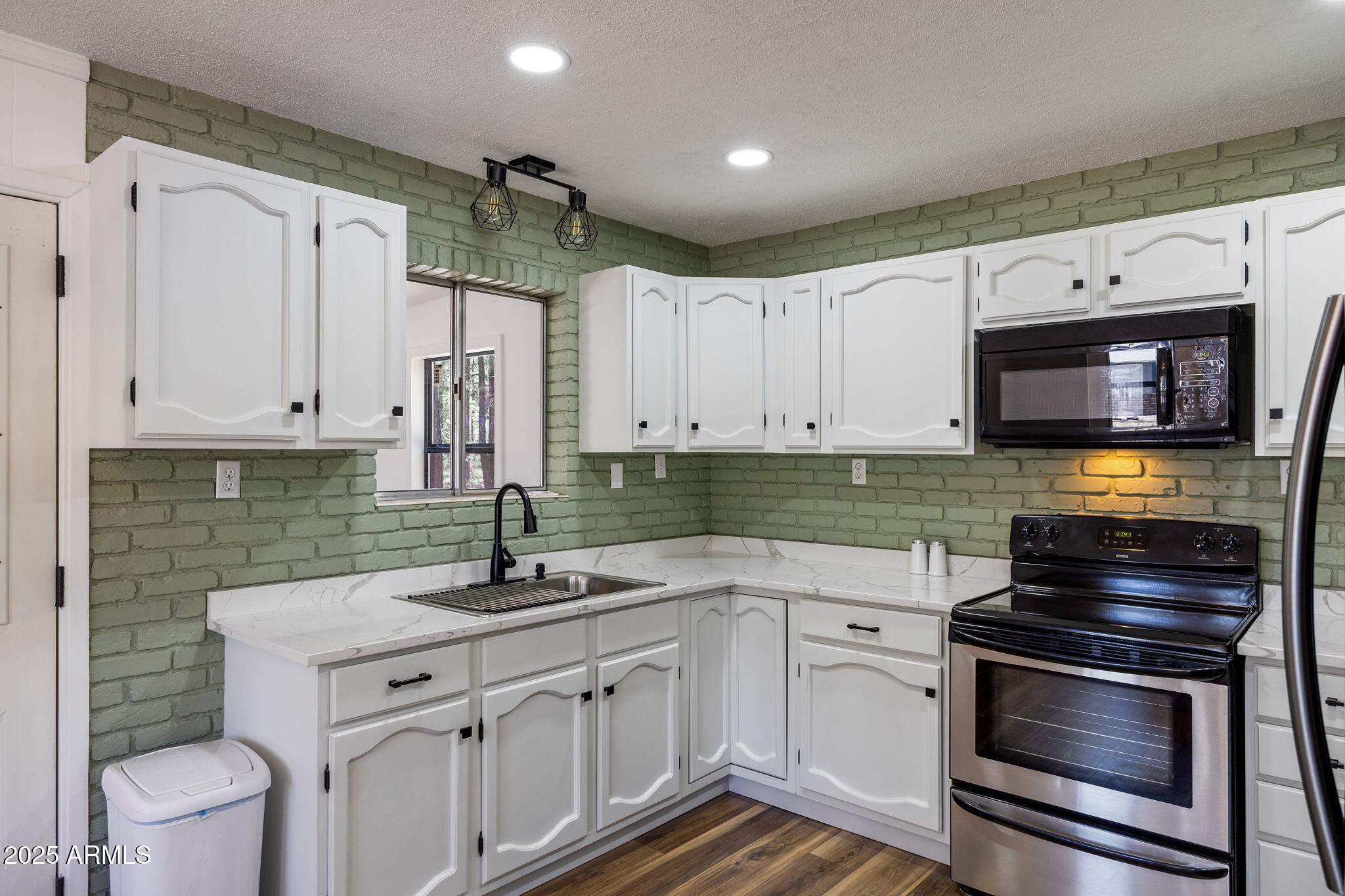 2127 Pony Road Overgaard, AZ 85933 - Photo 8 of 30 a kitchen with stainless steel appliances a stove a sink and a microwave