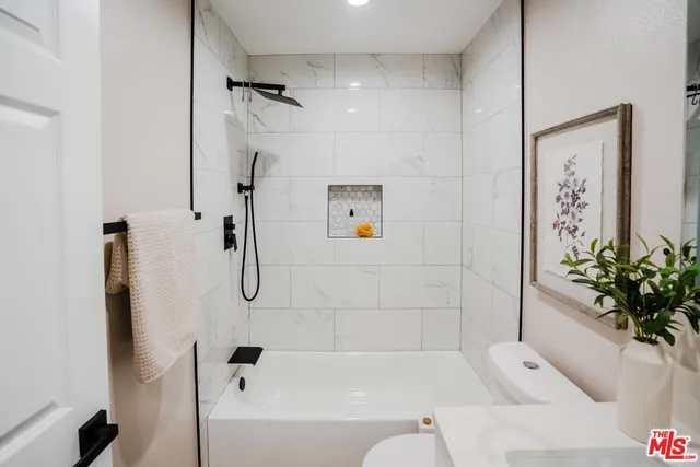 a bathroom with a bathtub and shower