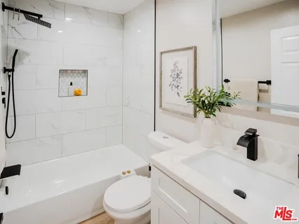 a bathroom with a sink a toilet and a tub